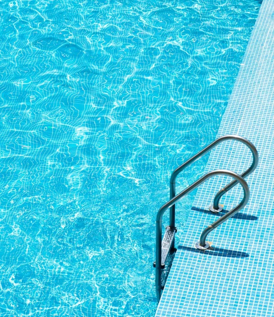Clear blue pool water with stainless steel pool handles